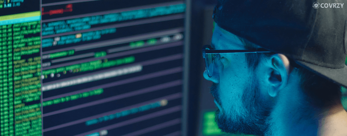 A man with spectacles looking at computer screen
