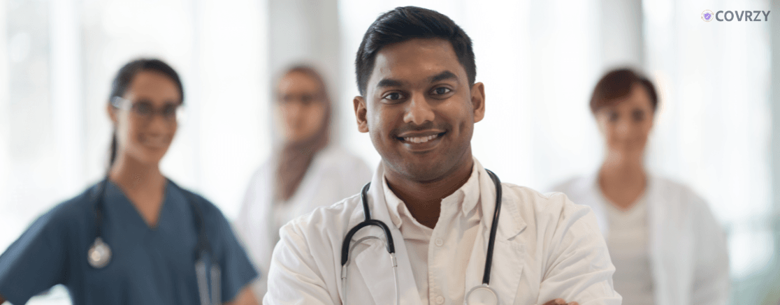 An Indian doctor smiling looking at the camera 