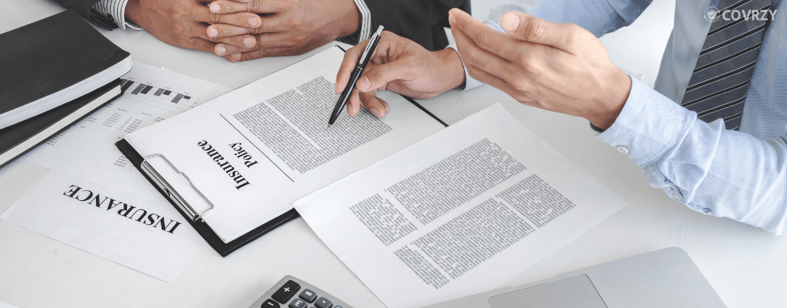 few employees working on insurance papers checking free look period