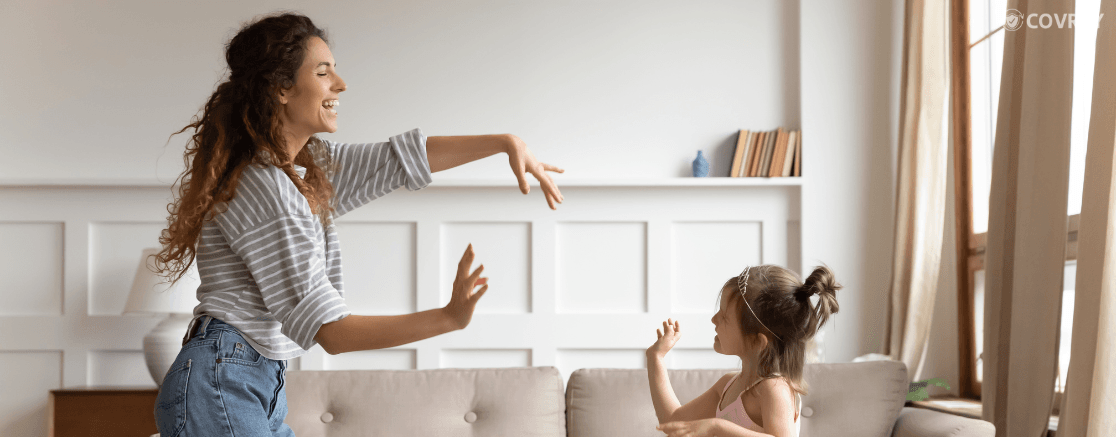 A woman babysitting a child by playing with her